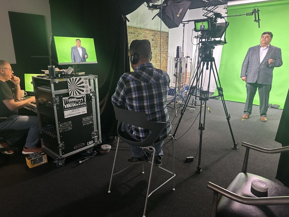 Production team filming a REALTOR member in the studio